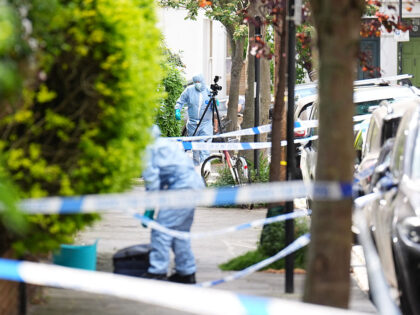 A forensics officer is seen in Kentish Town, north London. Police are investigating a fire